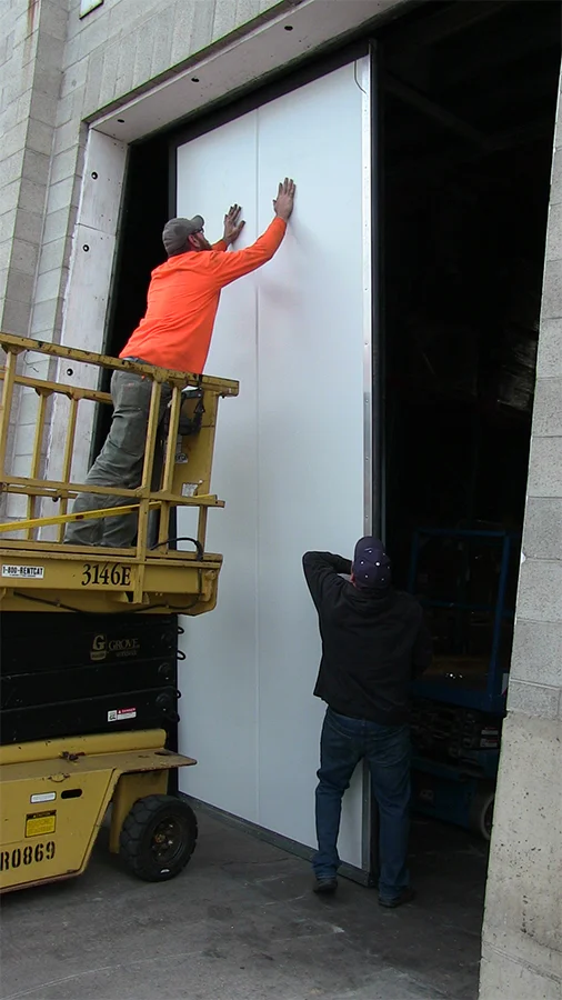 Carefully lifting the panels into place Carefully lifting the panels into place